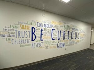 be curious wall sign