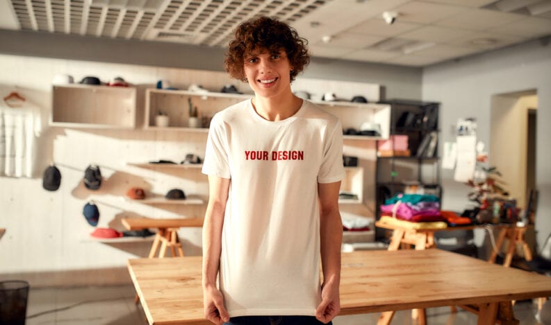 Branded apparel designer wearing customizable shirt in design studio