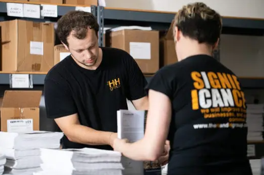 Two people work to fulfill an order at a warehouse.
