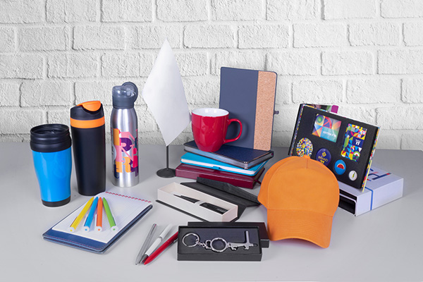 An image of some of the options available for branding, including a hat, pens, a travel mug, amongst other things.