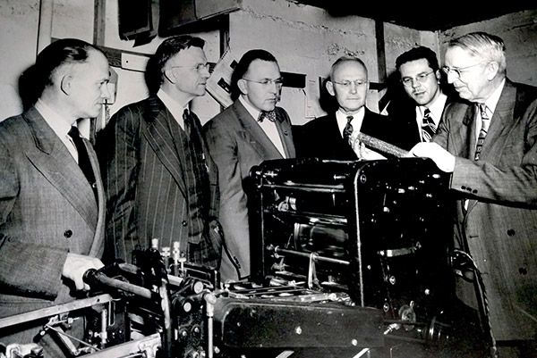 vintage photo of men at a printer