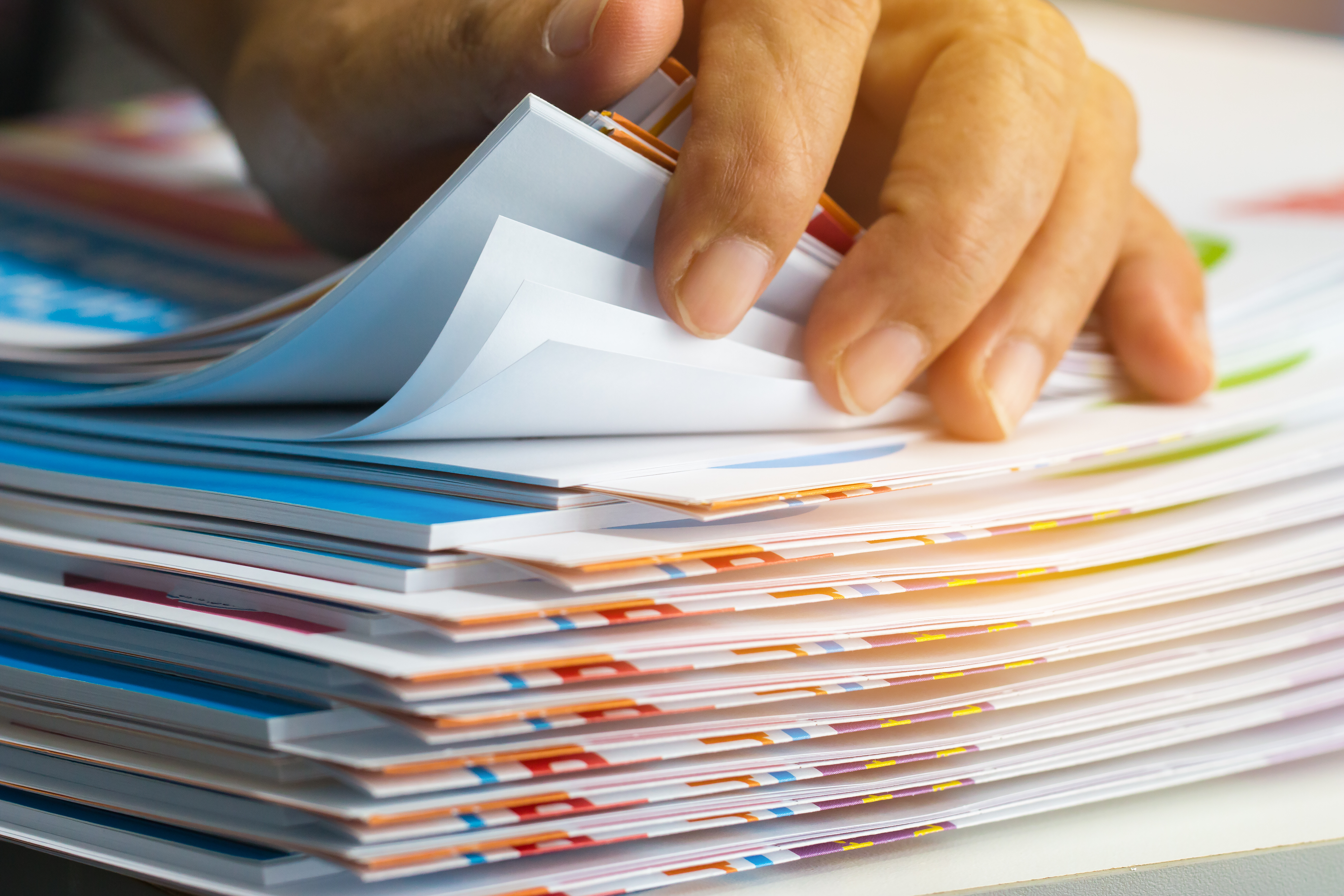 A person stacking brochures